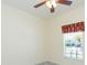 This bedroom features a ceiling fan, window with blinds and carpet flooring at 711 Parker Den Dr, Ruskin, FL 33570