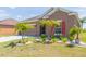 This home's exterior boasts meticulous landscaping with palm trees, offering curb appeal and a welcoming entrance at 711 Parker Den Dr, Ruskin, FL 33570