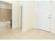 Light hallway leads to a bathroom with a shower-tub combo, showcasing the home's functional layout at 711 Parker Den Dr, Ruskin, FL 33570