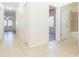 Hallway with tile flooring leading to the bedrooms and bathrooms, showing the home's layout at 711 Parker Den Dr, Ruskin, FL 33570
