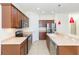 Bright kitchen featuring stainless appliances, wooden cabinets, and tile flooring at 711 Parker Den Dr, Ruskin, FL 33570