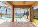 A beautiful screened-in lanai with a pool overlooking a serene lake at 711 Parker Den Dr, Ruskin, FL 33570
