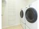 Bright laundry room features modern washer and dryer and ample storage space at 711 Parker Den Dr, Ruskin, FL 33570