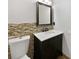 Cozy bathroom featuring a tiled backsplash, vanity with marble countertop, and toilet at 8114 Pond Shadow Ln, Tampa, FL 33635