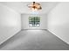 Spacious bedroom with neutral carpet, a ceiling fan and a large window for ample natural light at 8114 Pond Shadow Ln, Tampa, FL 33635