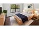 Stylish bedroom with a minimalist aesthetic, featuring a large window and modern decor at 8114 Pond Shadow Ln, Tampa, FL 33635