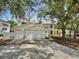 Elegant home featuring a three-car garage and well-maintained landscaping, creating curb appeal at 8114 Pond Shadow Ln, Tampa, FL 33635