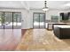 Open layout with kitchen, and access to screened patio and pool with tile flooring at 8114 Pond Shadow Ln, Tampa, FL 33635