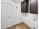 Laundry area with dark cabinets and tile flooring, including hookups for washer and dryer at 8114 Pond Shadow Ln, Tampa, FL 33635
