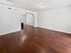 Bright living room featuring hardwood floors and an archway into the kitchen, great for entertaining at 8114 Pond Shadow Ln, Tampa, FL 33635