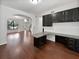 Inviting living room with archway, wood floors, and dark cabinets with light countertops at 8114 Pond Shadow Ln, Tampa, FL 33635