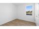 Bright bedroom featuring wood-look floors and a large window overlooking the neighborhood at 936 57Th N Ave, St Petersburg, FL 33703