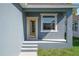 A yellow door and window with white trim are the design highlights of this entryway at 936 57Th N Ave, St Petersburg, FL 33703
