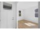 Bright entryway featuring wood-look tile floors, fresh white paint, and natural light at 936 57Th N Ave, St Petersburg, FL 33703