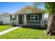 Lovely home featuring a welcoming porch and a beautifully landscaped front yard at 936 57Th N Ave, St Petersburg, FL 33703
