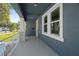 Enjoy the outdoors on this spacious covered front porch with modern railings, and ample natural light at 936 57Th N Ave, St Petersburg, FL 33703