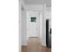 Bright hallway featuring wood-look tile floors, fresh white paint, and a modern light fixture at 936 57Th N Ave, St Petersburg, FL 33703