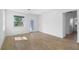 Sunlit room featuring wood-look floors, a glass back door and large window overlooking the yard at 936 57Th N Ave, St Petersburg, FL 33703