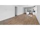 Bright, open-concept living space with wood-look floors and seamless transition to the kitchen at 936 57Th N Ave, St Petersburg, FL 33703
