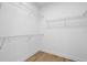 Spacious walk-in closet with shelving and wood-look floors provides ample storage at 936 57Th N Ave, St Petersburg, FL 33703