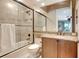 Bathroom with a glass-enclosed shower, granite countertops, and modern fixtures at 9630 Tree Tops Lake Rd, Tampa, FL 33626