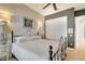 Comfortable bedroom with textured wall, wrought iron bed frame, and built-in closet space at 9630 Tree Tops Lake Rd, Tampa, FL 33626