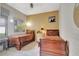 Bright bedroom featuring two twin beds with rich wood frames and neutral-toned walls with decorative art at 9630 Tree Tops Lake Rd, Tampa, FL 33626