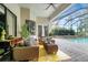 Comfortable covered patio with outdoor seating and a view of the sparkling pool at 9630 Tree Tops Lake Rd, Tampa, FL 33626