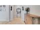 Elegant hallway features neutral paint, tile floor, decorative mirror, sconces, and decorative wood cabinet at 9630 Tree Tops Lake Rd, Tampa, FL 33626