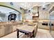 Spacious kitchen featuring granite countertops, a central island with seating, stainless steel appliances and custom cabinetry at 9630 Tree Tops Lake Rd, Tampa, FL 33626