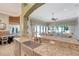 Granite countertops and stainless steel appliances enhance this kitchen and adjacent breakfast nook with water view at 9630 Tree Tops Lake Rd, Tampa, FL 33626