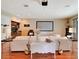 Spacious living room with hardwood floors, projector screen, and a wet bar for entertaining at 9630 Tree Tops Lake Rd, Tampa, FL 33626