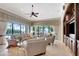 Bright living room featuring large windows, stylish furnishings, and a beautiful view of the pool area at 9630 Tree Tops Lake Rd, Tampa, FL 33626