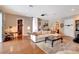 Open-concept living room with hardwood floors, a comfortable sofa, and a view into other rooms at 9630 Tree Tops Lake Rd, Tampa, FL 33626
