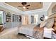 This main bedroom has a beautiful tray ceiling, stylish decor, and ample built-in storage at 9630 Tree Tops Lake Rd, Tampa, FL 33626