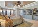 Serene bedroom with ample natural light, tray ceiling, a sitting area, and stylish decor at 9630 Tree Tops Lake Rd, Tampa, FL 33626