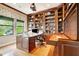 Executive office featuring custom built-in bookshelves and a large desk with natural light at 9630 Tree Tops Lake Rd, Tampa, FL 33626