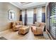 Sitting room with traditional furnishings, elegant window treatments, and natural light at 9630 Tree Tops Lake Rd, Tampa, FL 33626