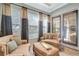 Comfortable sitting area with elegant sofas, bright windows, and outdoor views at 9630 Tree Tops Lake Rd, Tampa, FL 33626