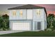 Charming two-story home with a two-car garage, lush green lawn, and tropical landscaping at 9967 Trellis Vine Way, Parrish, FL 34219