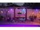 Backyard featuring a charming wooden swing set adorned with colorful lights, surrounded by decorative plants and gravel at 12901 129Th Ave, Largo, FL 33774