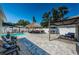 Expansive backyard featuring a swimming pool, thatched gazebo, covered seating area, and ample space for activities at 12901 129Th Ave, Largo, FL 33774