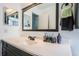 Clean bathroom with a dark vanity, framed mirror, and modern fixtures at 12901 129Th Ave, Largo, FL 33774