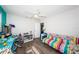 Bright bedroom featuring a colorful daybed, ceiling fan, and a well-lit desk area, perfect for a vibrant living space at 12901 129Th Ave, Largo, FL 33774