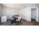 Dining room with modern light fixture, wood floors and convenient location to backdoor at 12901 129Th Ave, Largo, FL 33774