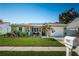 Charming single-story home featuring lush landscaping, a well-manicured lawn, and a welcoming front entrance at 12901 129Th Ave, Largo, FL 33774
