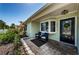 Cozy front porch with comfortable seating, decorative plants, and a stylish entrance door with a wreath at 12901 129Th Ave, Largo, FL 33774