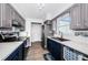 Bright kitchen showcasing stainless steel appliances, white countertops and modern cabinetry at 12901 129Th Ave, Largo, FL 33774