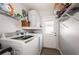Functional laundry room featuring a modern Samsung washer and dryer, shelving, and convenient exterior access at 12901 129Th Ave, Largo, FL 33774