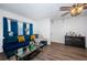 Well lit living room featuring hardwood floors, contemporary design, and modern ceiling fan at 12901 129Th Ave, Largo, FL 33774